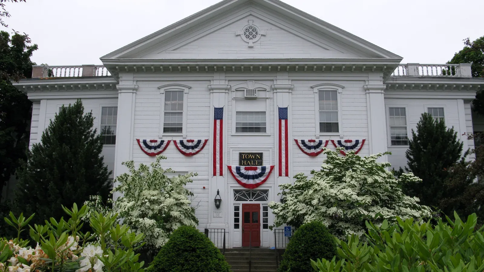 Danvers Town Hall, a white Colonial Revival building draped in patriotic bunting, Danvers, Massachusetts