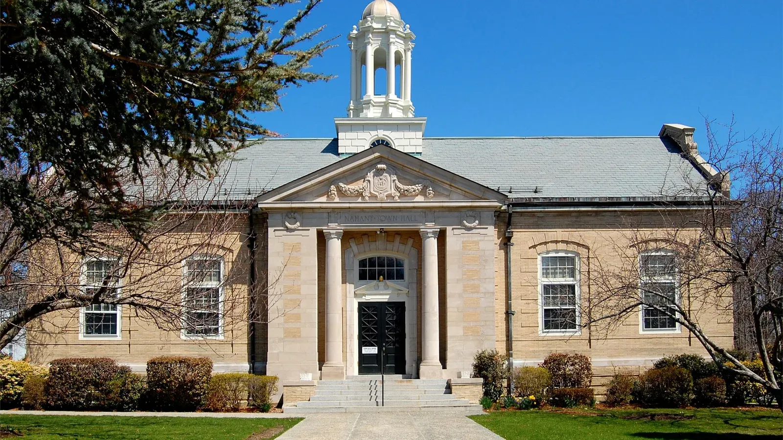 Nahant Town Hall, a Classical Revival building with a white cupola and columned entry, Nahant, Massachusetts